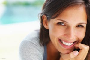 Woman smiling with gray top