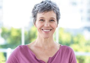 Woman with gray hair and pink top