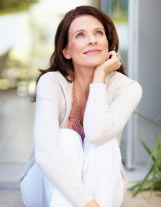 woman wearing white and smiling