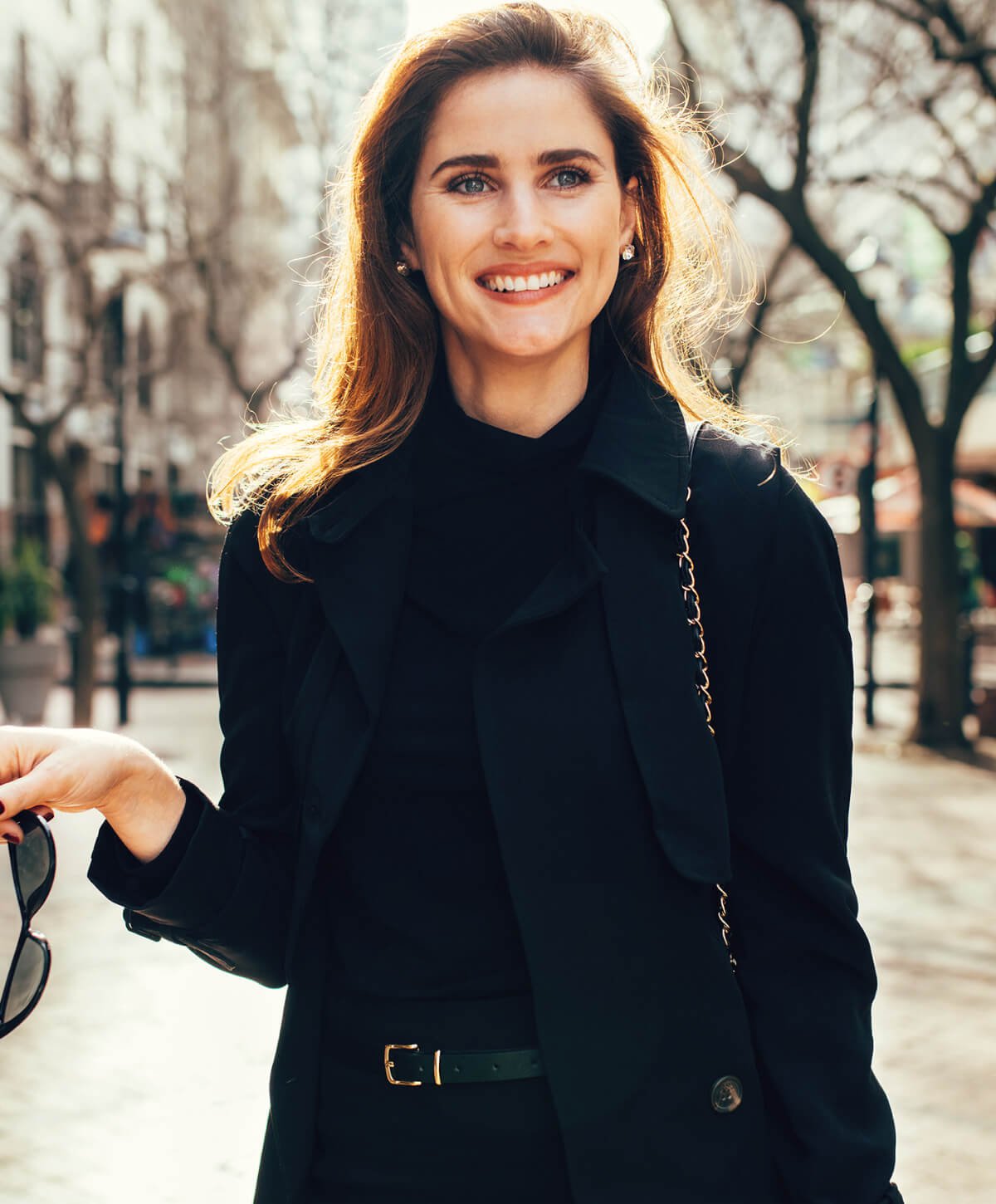 tummy tuck patient model in a navy blue coat walking in the snow